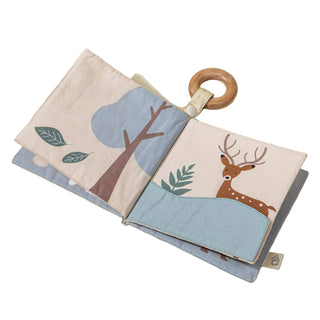 Children's book with a wooden ring on a light beige background