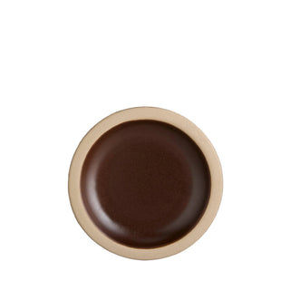 Brown ceramic plate with beige rim on a light gray background