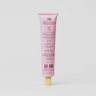 Pink tube of lip balm on a white background