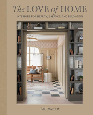 Book cover of 'The Love of Home' by Kate Marker, featuring a room with bookshelves and decor.
