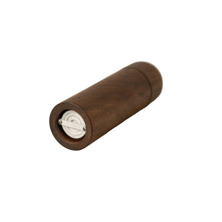 Wooden pepper grinder on a beige fabric background