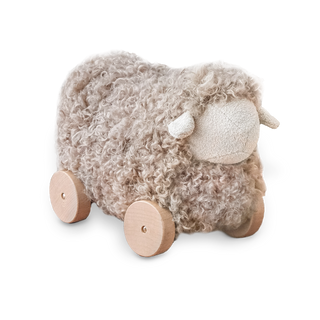 Plush sheep toy with wheels on a white background