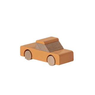 Wooden toy car on a beige background