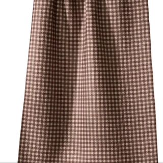 Checkered towel hanging on a line with a brown background