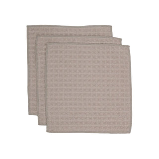 Two beige textured towels stacked on a white background